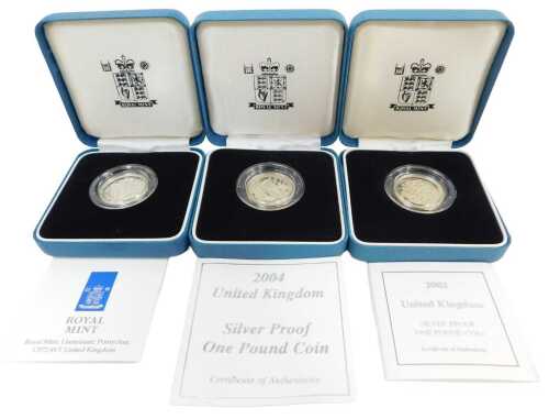 Three Royal Mint silver proof one-pound coins, for 1998, 2002 and 2004, each boxed with a...