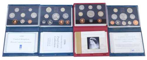 Four Royal Mint United Kingdom proof coin collections, for 1990, 1996, 1997, and 2002.