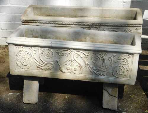 Two composition stone rectangular garden planters, each of a different design, with U-shaped...