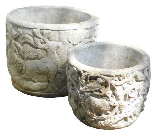 A composition stone garden planter, of cylindrical form, carved with animals, to include a stag,...