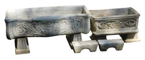 Two rectangular composition stone garden planters, of differing designs, 73cm wide and 38cm wide,...