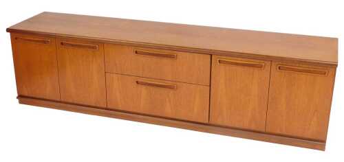 A G-Plan style low sideboard or unit, with an arrangement of two pairs of drawers and two pairs...