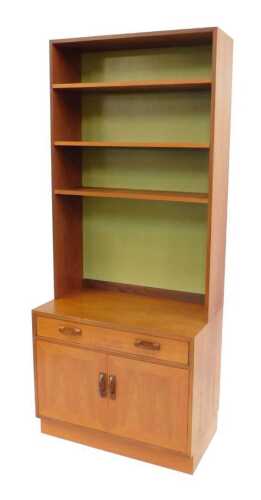 A G-Plan teak dresser, the top with three shelves, the base with a drawer and two doors, on a...