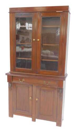 A late 19th/early 20thC walnut bookcase, the top with two glazed doors, the base with a frieze...