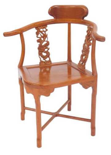 An Oriental hardwood corner chair, with dragon-carved splats, and a solid seat, on shaped legs...