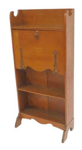 An early 20thC oak Arts and Crafts student's bureau, the fall with brass strap hinges and handle...