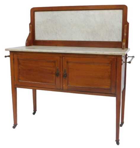 An Edwardian mahogany wash stand, the raised back with a white marble insert, the base with a...