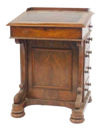 A Victorian walnut Davenport, the top with a raised gallery, above a fall inset in black leather,...