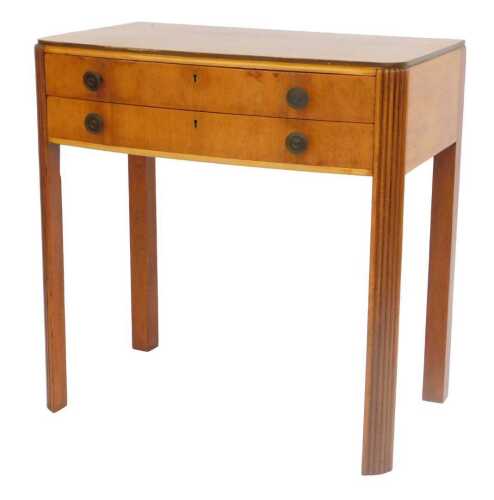 An Art Deco walnut canteen chest, the bow fronted top with a moulded edge, above two fitted...