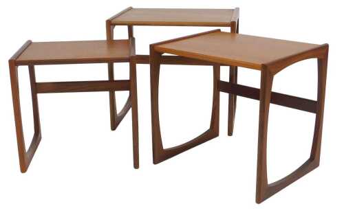 A nest of three G-Plan teak tables, each with a rectangular top, on end supports, 49cm high,...