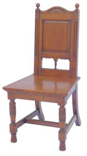 A late 19thC oak hall chair, the panelled back with turned finials and fan decoration, with a...