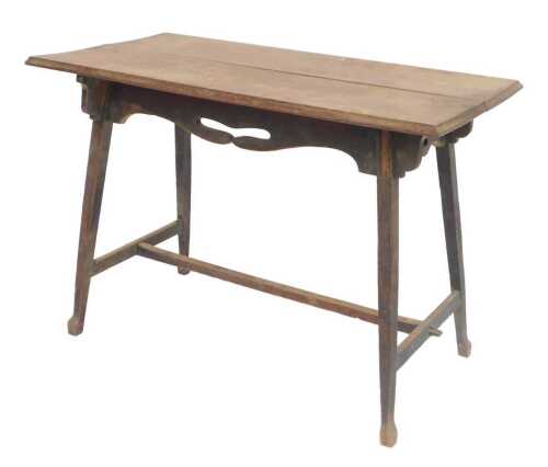 An Arts and Crafts oak centre table, the rectangular planked top with a moulded edge, above a...