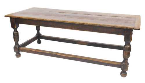 A 17thC style oak refectory table, the planked top with cleted ends, above a plain frieze, on...