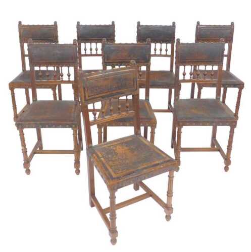 A set of eight late 19thC Continental walnut dining chairs, each upholstered in brown leather...