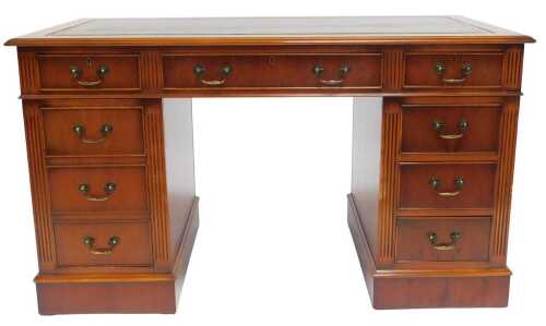 A yew pedestal desk, the rectangular top with a green and gilt tooled leather insert and a...