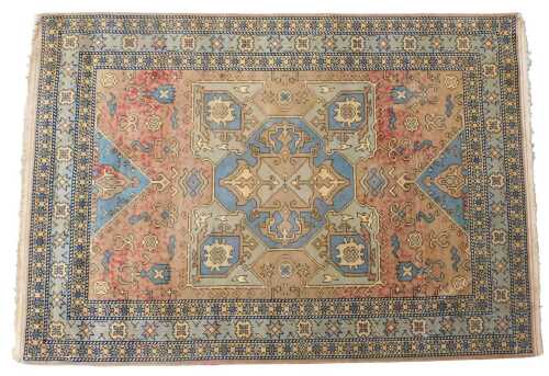 A Heriz pale green ground rug, decorated with a central medallion within one wide and multiple...