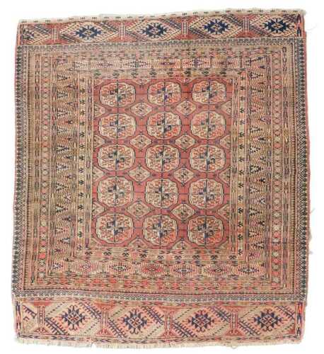A Turkman red ground rug, decorated with three rows of medallions within multiple narrow borders,...