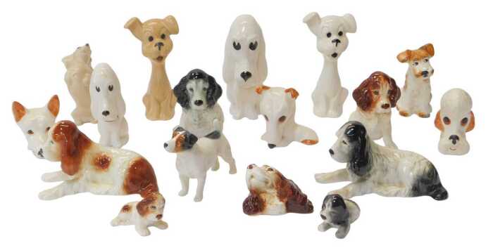 A group of Sylvac pottery dog figures, to include a Spaniel wall plaque, 9cm high, various...