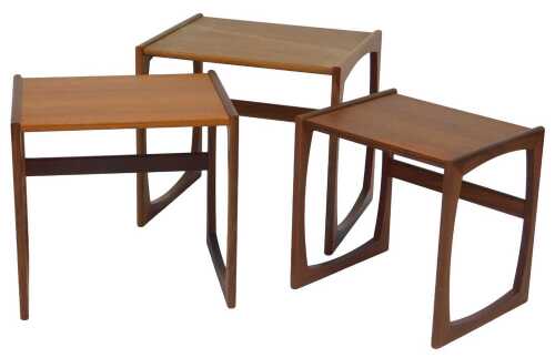 A nest of three G-Plan teak tables, each on end supports, 48cm high, 53cm wide.