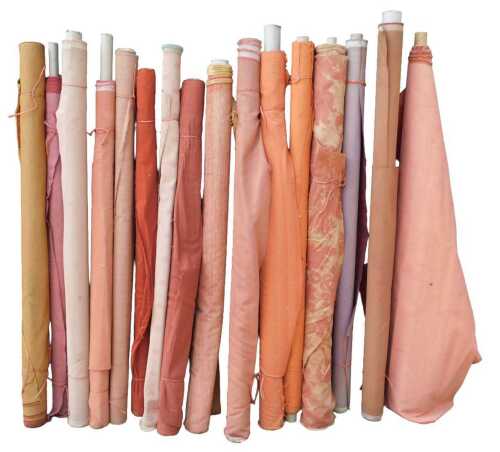 Various bolts of upholstery fabric, differing designs, predominantly red and pink. (a quantity)