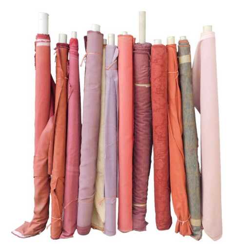 Various bolts of upholstery fabric, differing designs, predominantly red and pink. (a quantity)