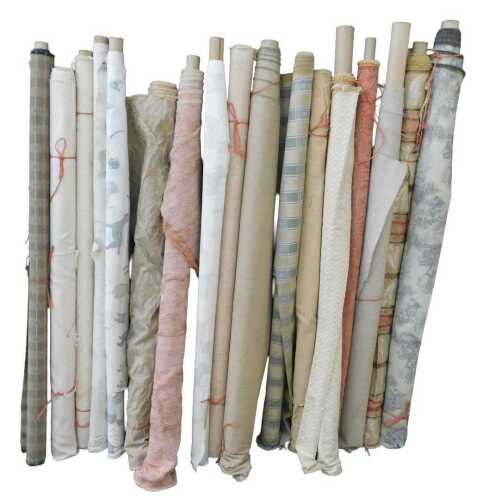 Various bolts of upholstery fabric, differing designs, to include fabric decorated with dogs,...