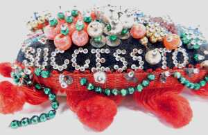 A World War I sweetheart beadwork pin cushion, of heart form, bearing the phrase Success to Our... - 2