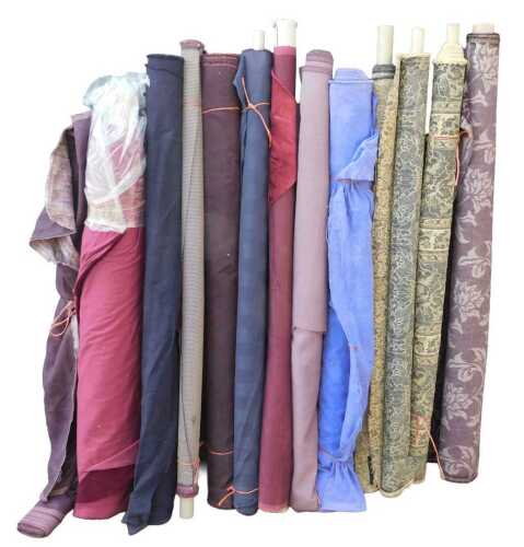 Various bolts of upholstery fabric, differing designs, predominantly purples. (a quantity)