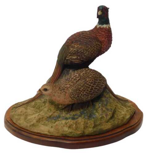 A Northern Lights resin group modelled as two pheasants, signed North Light 82 J Stanbridge,...
