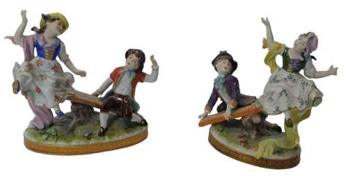 A pair of Volkstedt porcelain figure groups, each modelled as a girl and boy playing on a seesaw,...