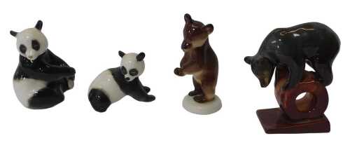 A group of Lomonosov and other pottery figures, comprising two pandas, and two bears.