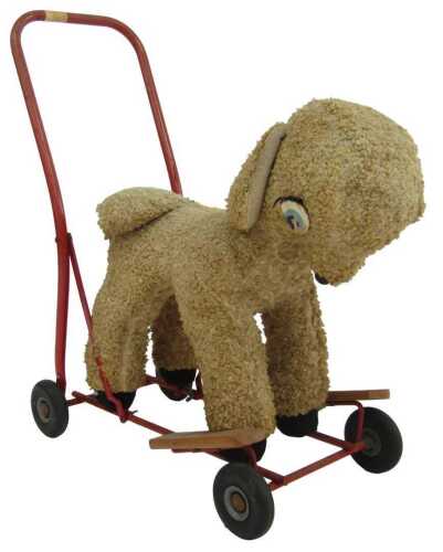 A push-a-long plush lamb, possibly Tri-ang, on a red tubular frame, 63cm high.