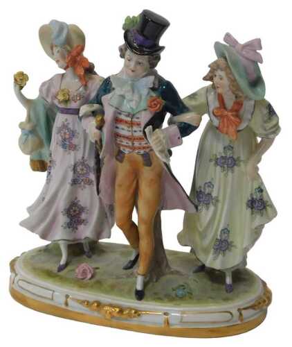 An early 20thC German porcelain figure group, modelled as a gentleman flanked by two ladies in...