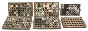 Six stained pine printer's drawers, containing some ceramic inkwells, each 29cm wide.