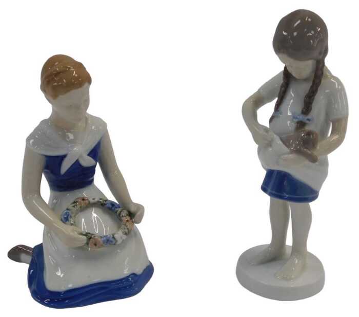 Two Bing & Grondahl porcelain figures, modelled as a girl with pigtails, holding a kitten, No....