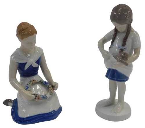 Two Bing & Grondahl porcelain figures, modelled as a girl with pigtails, holding a kitten, No....