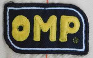 An OMP racing suit and a Jays racing suit, with various applied patches including Dunlop, Rolex... - 2