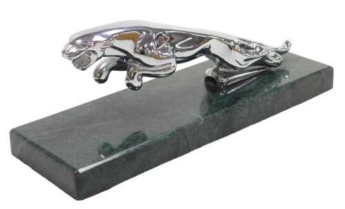 A chrome plated Jaguar car mascot, on green marble plinth, 22.5cm long overall.