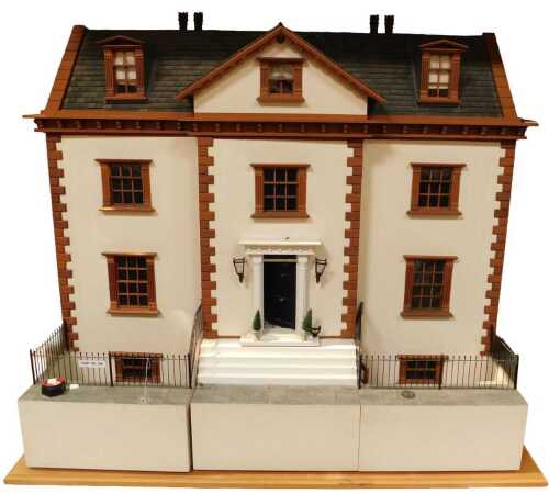 A Georgian style eleven room doll's house, with basement and frontage, with wired lighting and...