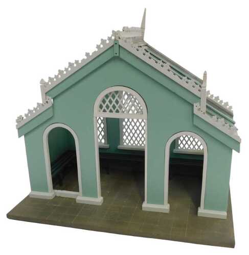 A Victorian-style green-painted pavilion, 1:12 scale, with internal benches and a glass roof.