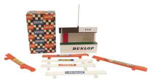 A Scalextric A202, BRM racing pit with Dunlop advert, six safety fences with advertising...
