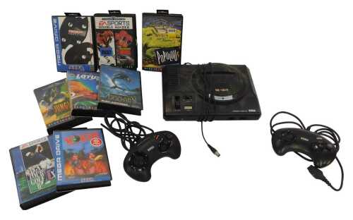 A Sega Mega Drive, with controllers and cables, Jungle Strike, Worms, Echo the Dolphin, Lotus...