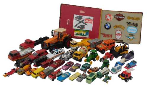 Various playworn diecast, and a photo album containing automotive stickers and badges, including...