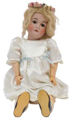 A German bisque headed doll, possibly Simon Halbig or Armand Marseille, with clothing, open and...