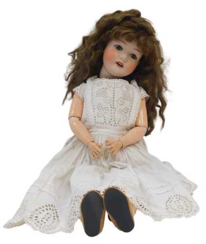 A German bisque porcelain headed doll, by Heubach Koppelsdorf, with cotton clothing and...