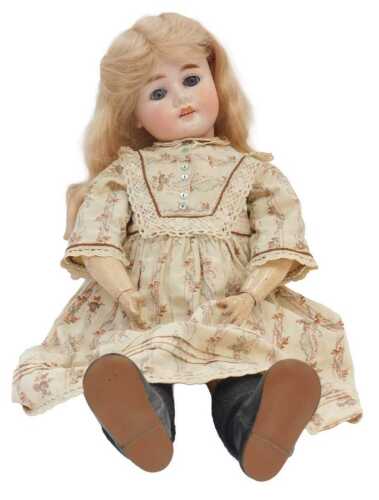 A German Porcelain headed doll by Armand Marseilles, with sleeping eyes, articulated body, and...