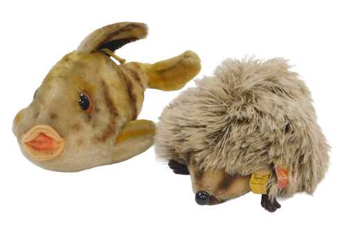A Steiff Joggi plush hedgehog, with label, 18cm long, and a Steiff Flossy fish, with button to...