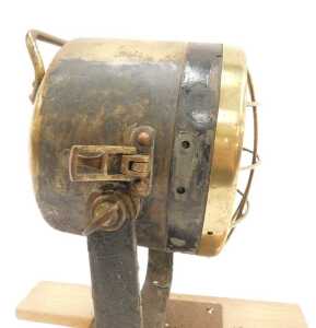 A brass ship's spotlight, mounted on a wooden plinth. - 3