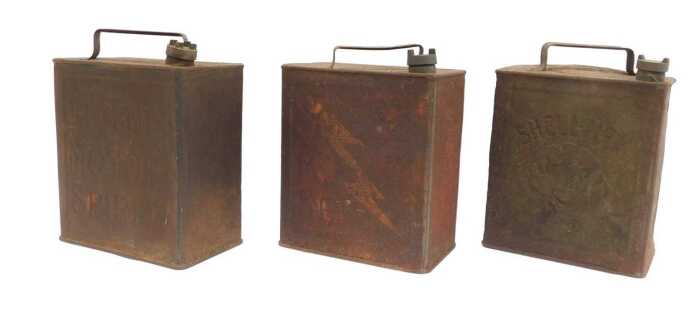 Three petrol cans, including Shell Motor Spirit, Shell Mex, and Regent Motor Spirit.