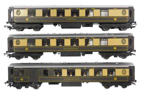 Three Hornby OO gauge Pullman coaches, including Ibis, Lucille, and car No. 93 in umber and cream.